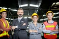 Senior businessman manager with industrial engineer women with safety helmet stand in line at manufacturing industry factory. Royalty Free Stock Photo