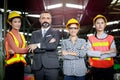 Senior businessman manager with industrial engineer women with safety helmet stand in line at manufacturing industry factory. Royalty Free Stock Photo