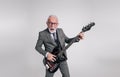 Senior businessman with mouth open singing ecstatically and playing guitar over white background Royalty Free Stock Photo