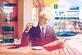 Senior businessman with newspaper drinking coffee Royalty Free Stock Photo