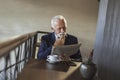 Senior businessman reading newspapers and drinking coffee Royalty Free Stock Photo