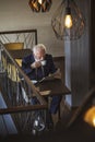 Senior businessman reading newspapers and drinking coffee Royalty Free Stock Photo