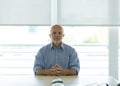 Senior businessman sat at desk in office Royalty Free Stock Photo