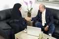 Senior Businessman Shaking hands with Woman wearing hijab Royalty Free Stock Photo