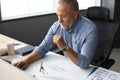 Senior businessman with a stylish short beard working on laptop computer at his office desk Royalty Free Stock Photo