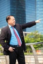 Senior businessman in suit pointing at a direction Royalty Free Stock Photo