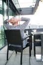 Senior businessman with a tablet in rooftop cafe