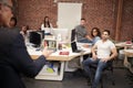 Senior Businessman Talking At Meeting Of Casually Dressed Business Team In Open Plan Office Royalty Free Stock Photo