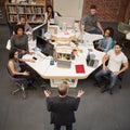 Senior Businessman Talking At Meeting Of Casually Dressed Business Team In Open Plan Office Royalty Free Stock Photo