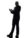 Senior businessman text messaging silhouette Royalty Free Stock Photo