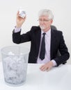 Senior businessman throwing paper