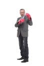 senior businessman wearing a gray suit with boxing gloves in a victory pose Royalty Free Stock Photo