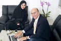 Senior Businessman working with Arabian Businesswoman wearing hijab