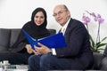 Senior Businessman working with Arabian Businesswoman wearing hijab