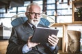 Senior businessman working on digital tablet. Close up. Royalty Free Stock Photo