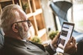 Senior businessman working on his digital tablet. Close up. Royalty Free Stock Photo