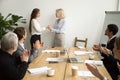 Senior businesswoman boss promoting thanking female employee whi