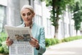 senior businesswoman reading newspaper outdoors. Royalty Free Stock Photo