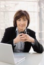 Senior businesswoman sitting at desk Royalty Free Stock Photo