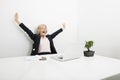 Senior businesswoman yawning while looking at laptop in office