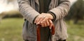 Senior cane, hands and person in nature for walking, relax and in a park for peace. Closeup, standing and an elderly Royalty Free Stock Photo