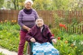 Senior care assistant with very old disabled woman in nursing home. Royalty Free Stock Photo