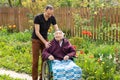 Senior care assistant with very old disabled woman in nursing home. Royalty Free Stock Photo