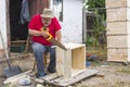 Senior carpenter making beehive