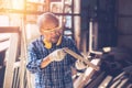 Senior Carpenter man Wood worker working hand made furniture in shop factory industry. male wooden craftsman builder working in Royalty Free Stock Photo