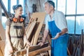 Senior carpenter sharing wisdom with younger aspiring colleague Royalty Free Stock Photo