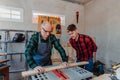 Senior carpenter teaching a younger man how to work Royalty Free Stock Photo