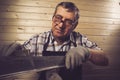 Senior carpenter working in his workshop