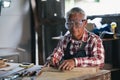 Senior carpenter working on woodworking machines in carpentry shop. man works in a carpentry shop. Royalty Free Stock Photo