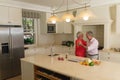 Senior caucasian couple dancing together and smiling in kitchen Royalty Free Stock Photo