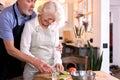 senior caucasian couple having fun in kitchen with healthy food, cooking meal at home Royalty Free Stock Photo