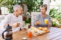 Senior caucasian couple smiling happy having breakfast at the terrace Royalty Free Stock Photo