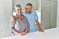 Senior caucasian couple smiling happy and hugging standing at the kitchen Royalty Free Stock Photo