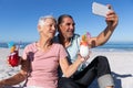 Senior Caucasian couple taking a selfie at the beach. Royalty Free Stock Photo