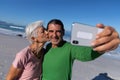 Senior Caucasian couple taking a selfie at the beach. Royalty Free Stock Photo