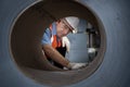 Senior caucasian engineer worker is examining the stainless galvanized metal sheet roll inside the warehouse factory for roofing Royalty Free Stock Photo