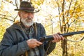 Senior hunter with gun ready to shoot his rifle Royalty Free Stock Photo