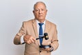 Senior caucasian judge man using gavel relaxed with serious expression on face Royalty Free Stock Photo