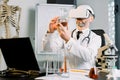 Senior Caucasian male doctor, scientist, virologist, wearing virtual reality glasses for imagination, conducting Royalty Free Stock Photo