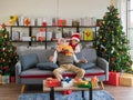 Senior Caucasian man excited with embracing behind with surprise gift from his wife while sitting on sofa couch in living room