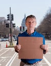 Senior man holding a blank cardboard sign in Pennsylvania Avenue, DC Royalty Free Stock Photo