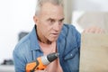 senior caucasian man in home workshop with voting sticker Royalty Free Stock Photo