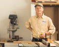 Senior caucasian man in home workshop with voting sticker Royalty Free Stock Photo