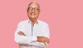 Senior caucasian man wearing business shirt and glasses happy face smiling with crossed arms looking at the camera Royalty Free Stock Photo