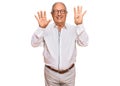 Senior caucasian man wearing business shirt and glasses showing and pointing up with fingers number nine while smiling confident Royalty Free Stock Photo