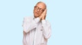 Senior caucasian man wearing business shirt and glasses sleeping tired dreaming and posing with hands together while smiling with Royalty Free Stock Photo